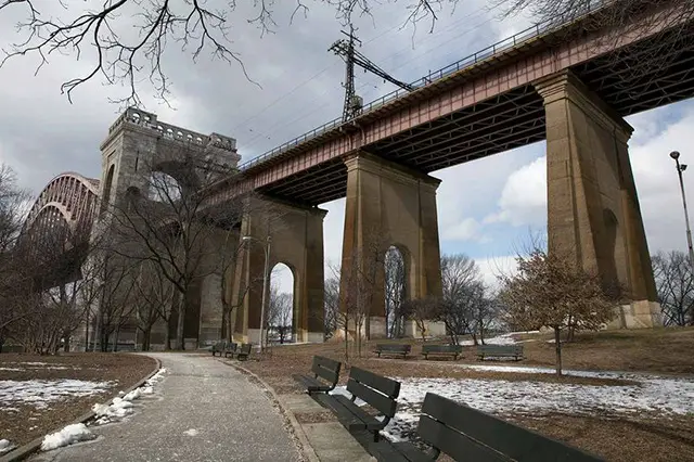The Hell Gate Bridge towers over Astoria Park in Queens